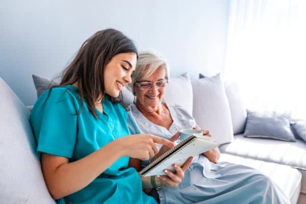 Student caregiver working with senior client